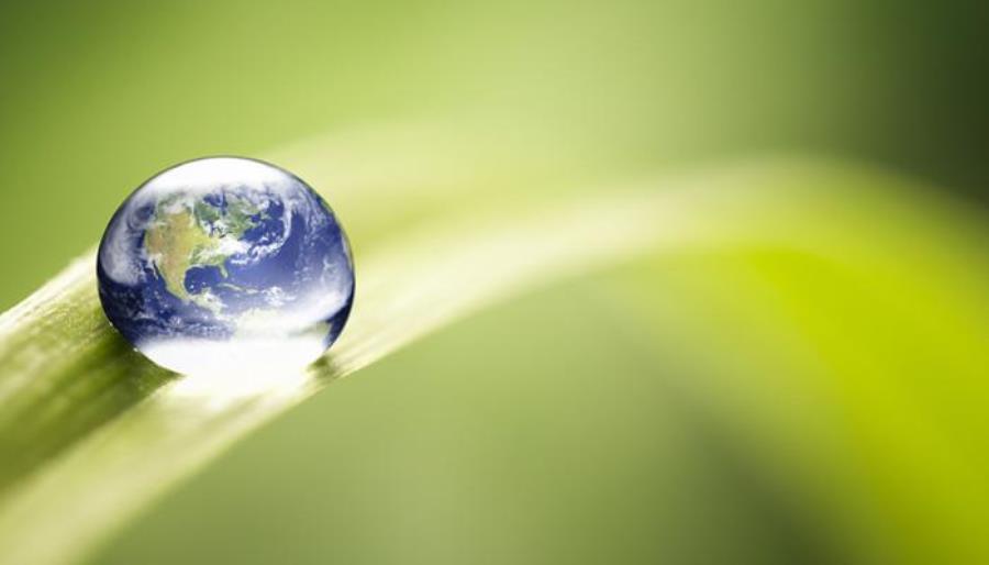 Raindrop with the earth inside resting on a leaf