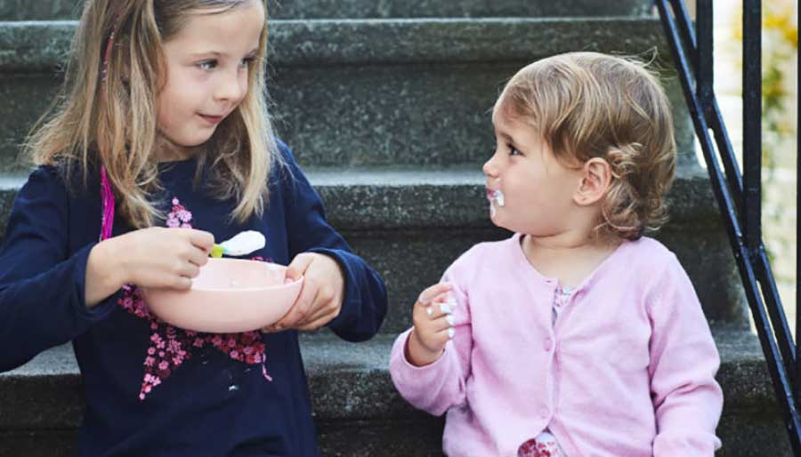 Two girls on stairs yogurt