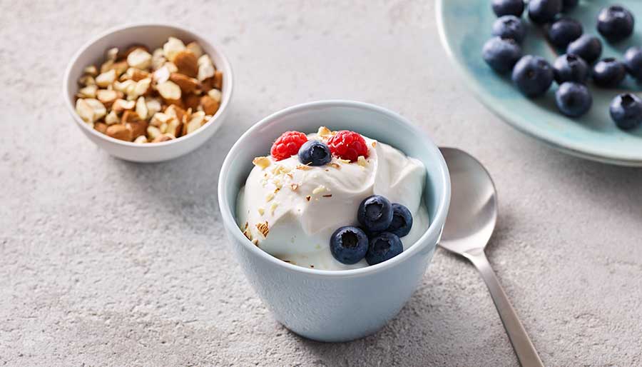 Bowls with yogurt, nuts and blueberries