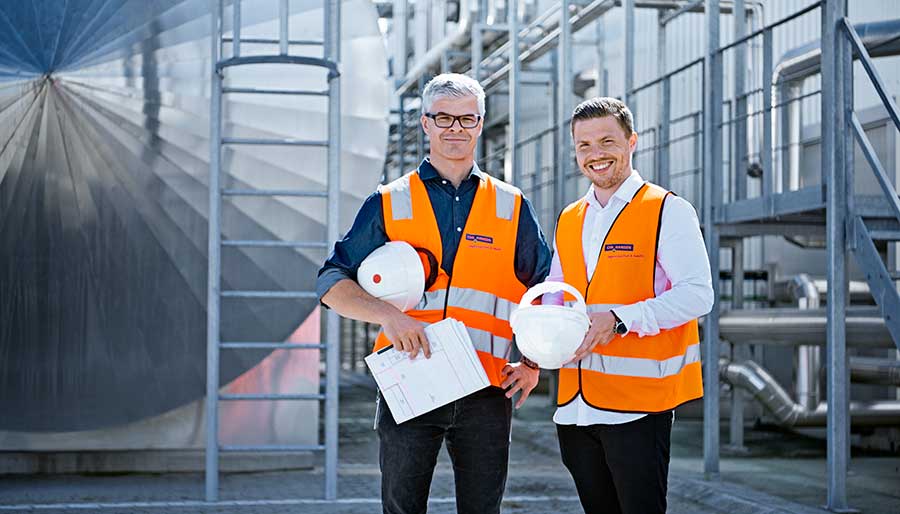 Two men standing at production site