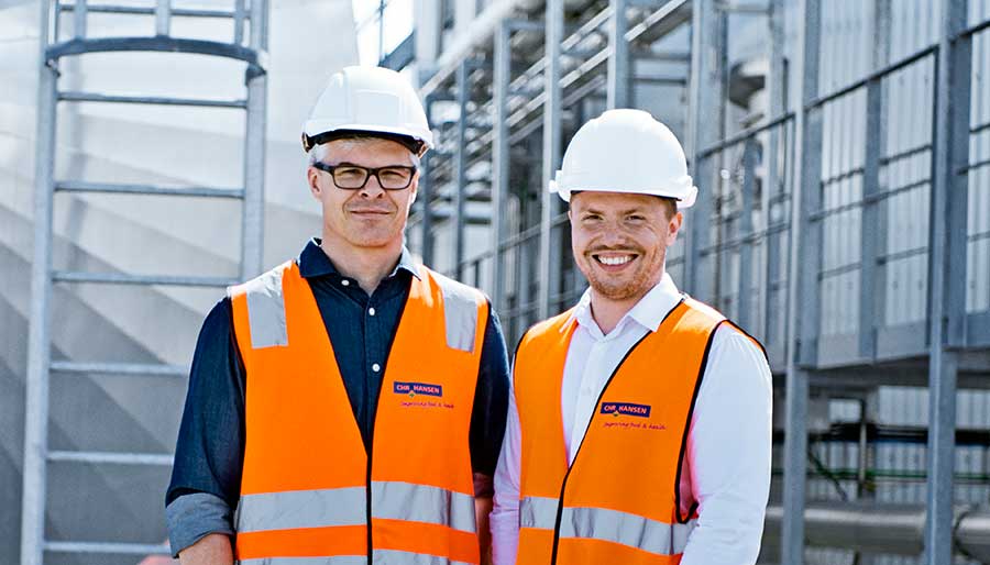 Two men standing at production site