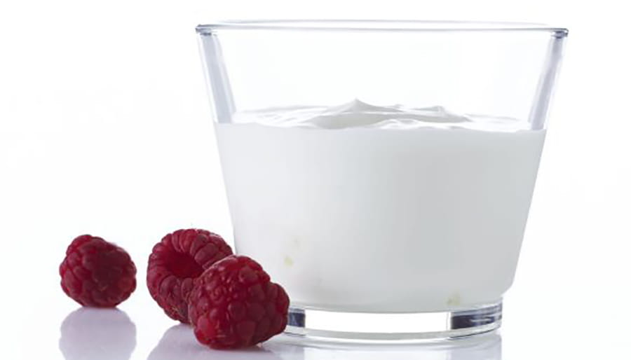 Portion of creamy yogurt with raspberries