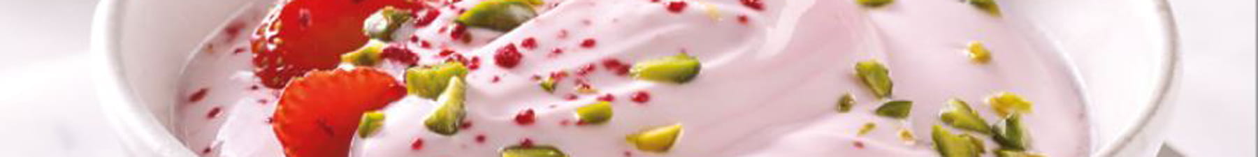 Yogurt in bowl with strawberry and pistachio