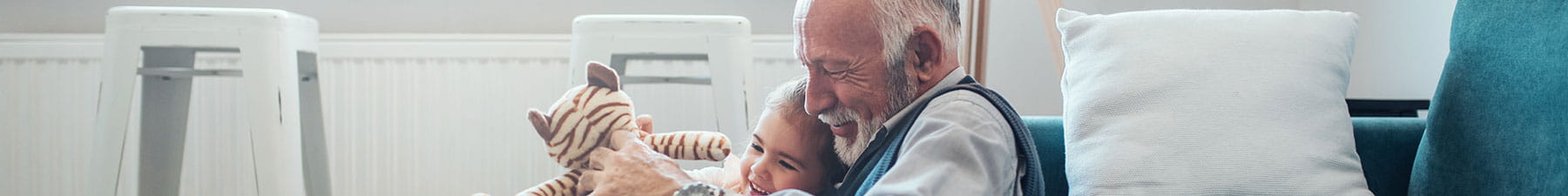 Elderly man and child with stuffed animal
