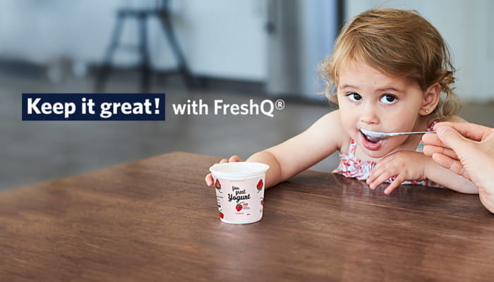 Girl eating yogurt with FreshQ bioprotective cultures 